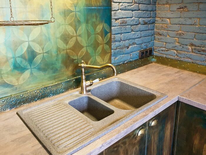 Modern kitchen sink with unique countertop and backsplash design