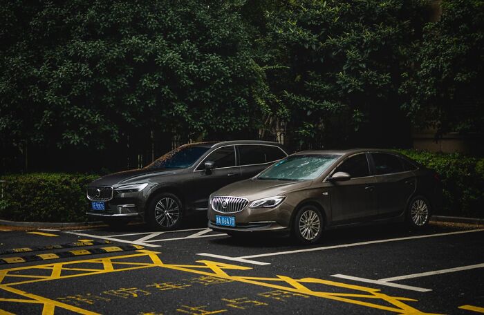 Two cars parked in a lot, representing a situation in satisfying revenge stories.