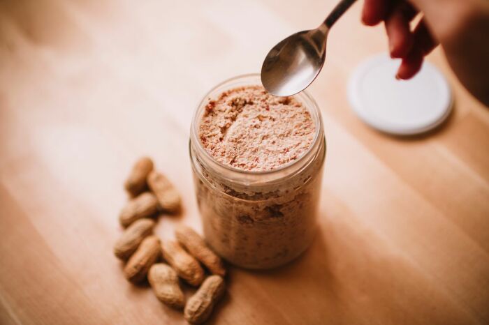 Peanut butter powder in jar with peanuts showcasing practical life hacks