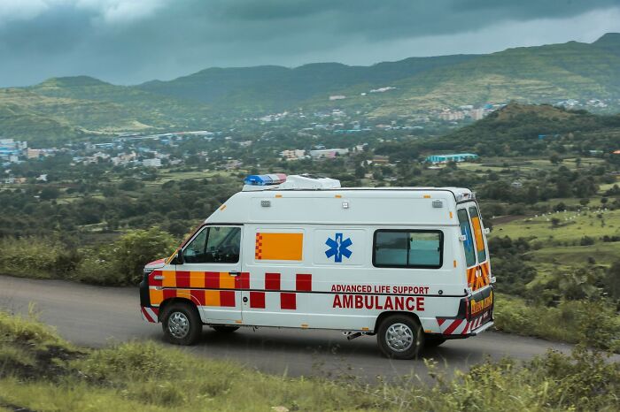 Ambulance driving down a rural road, representing satisfying revenge stories.
