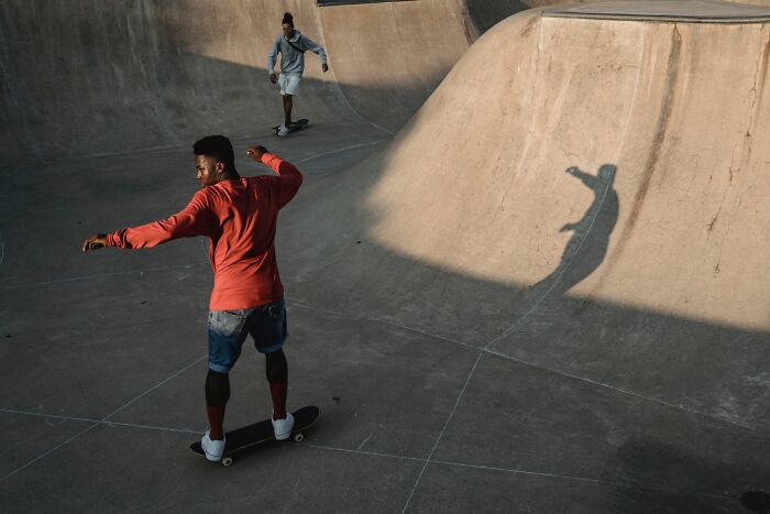 Two young men skateboarding at a park reflecting on reasons why they walked away from marriage