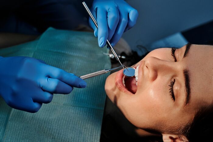 Patient receiving dental care with dentist using dental tools