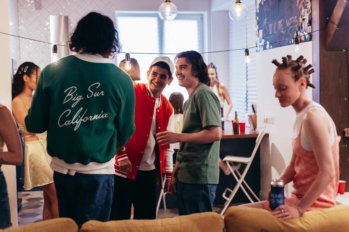A group of friends talking at a party, showcasing the urgent feeling that makes someone want to leave