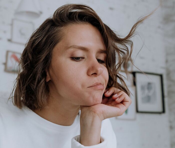 A thoughtful-looking woman, highlighting things women wish they knew earlier