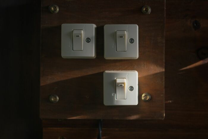 Light switches on wooden panel symbolizing lowkey acts to get back at an ex