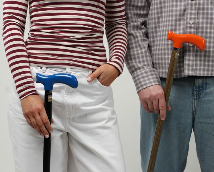Close-up of young people holding colorful mobility aids including walking canes