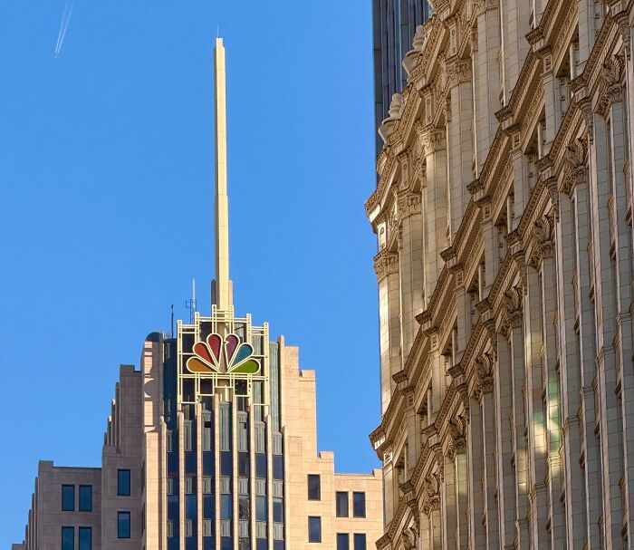 The NBC logo on a tall city building, representing media companies consumers refuse to support