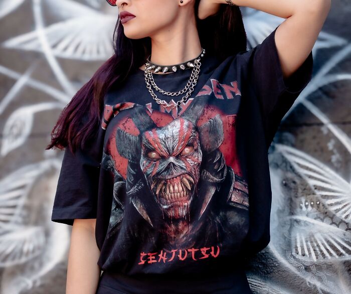 Woman wearing graphic tee with edgy design and layered chains