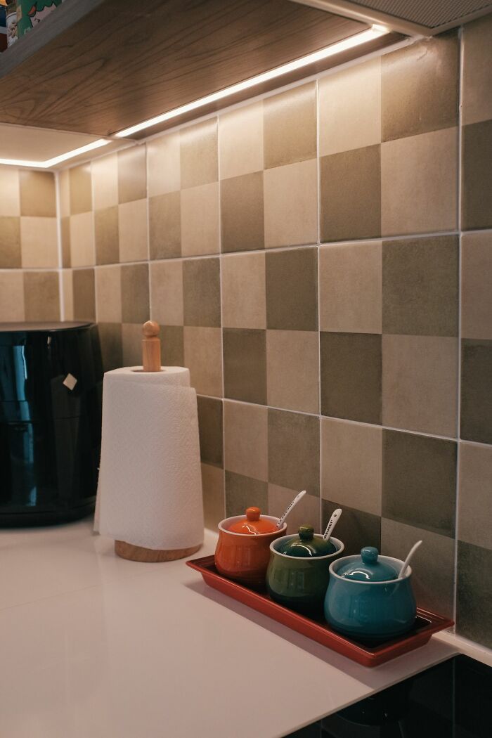 Under cabinet lighting illuminating kitchen backsplash and countertop