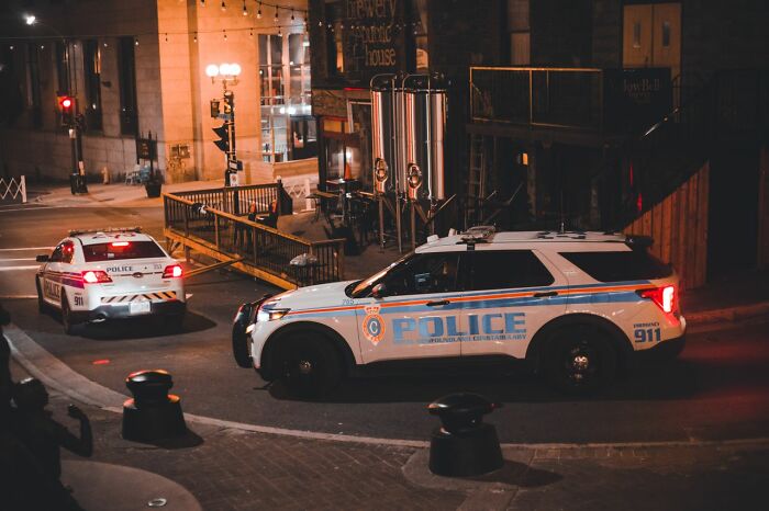 Police cars parked on a city street at night, responding to funny instances when folks failed embarrassingly.