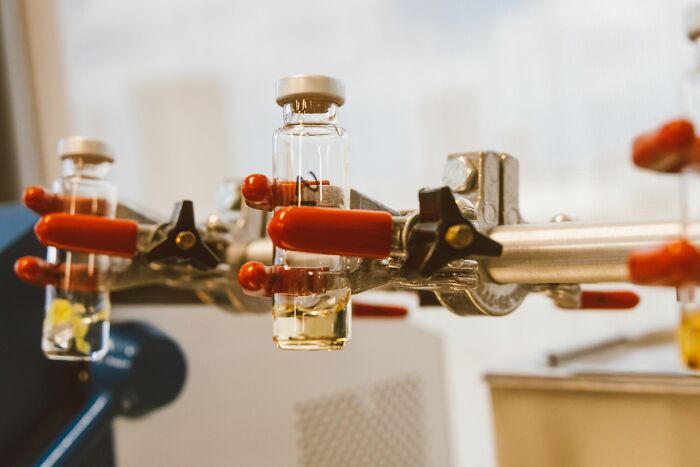 Laboratory glass vials in a test setup representing controversial companies consumers refuse to fund
