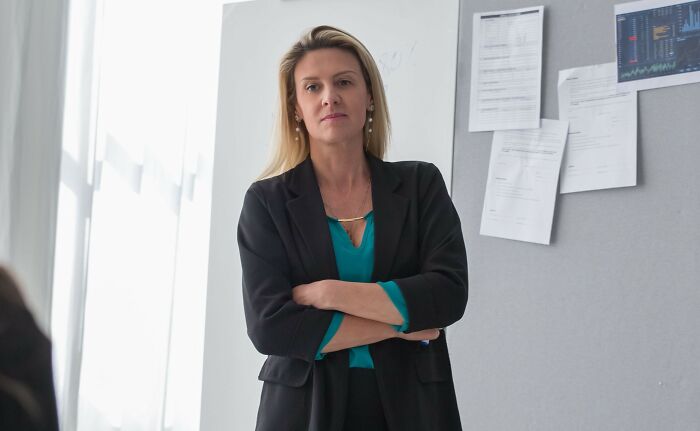 Serious woman standing with arms crossed addressing microaggressions