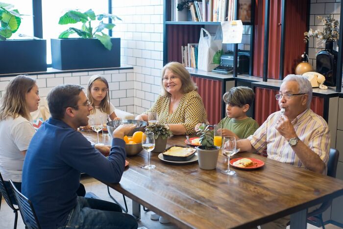 Family gathered at dining table illustrating kids' stories about Karens