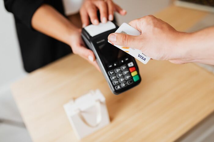 A customer making a contactless card payment as part of clever life tricks