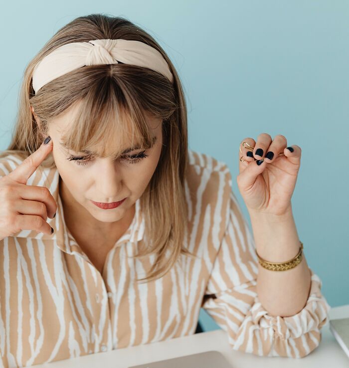 A focused woman working at her desk, pondering things women wish they had known sooner