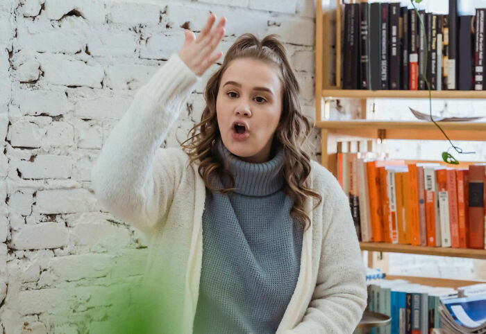Young woman angrily gesturing during a Karen encounter