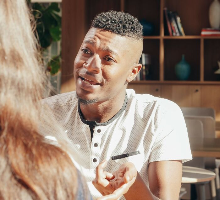 Man attentively discussing microaggressions in a conversation