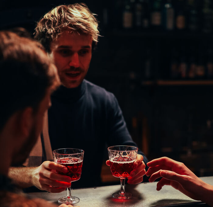 Customers enjoying drinks at a California bar counter.