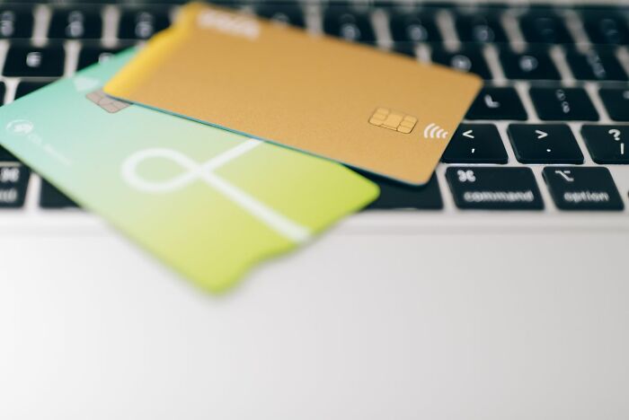Two credit cards resting on a laptop keyboard demonstrating clever life tricks for smart shopping