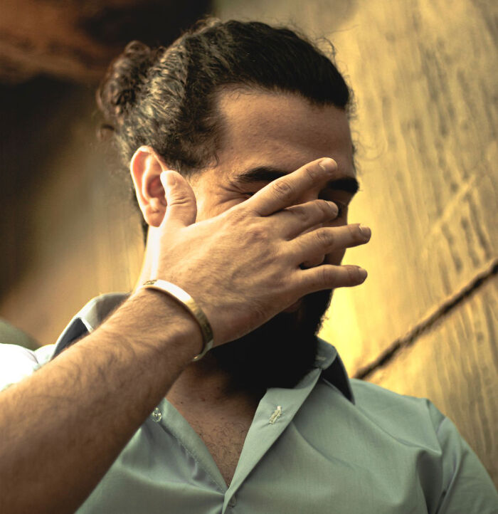 A man with a facepalm gesture representing a frustrating revenge story