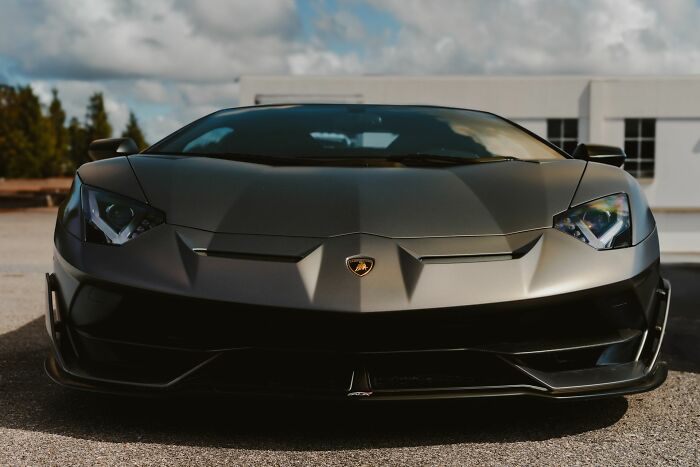 A luxurious dark grey sports car illustrating materialism and financial stress that made men walk away from marriage