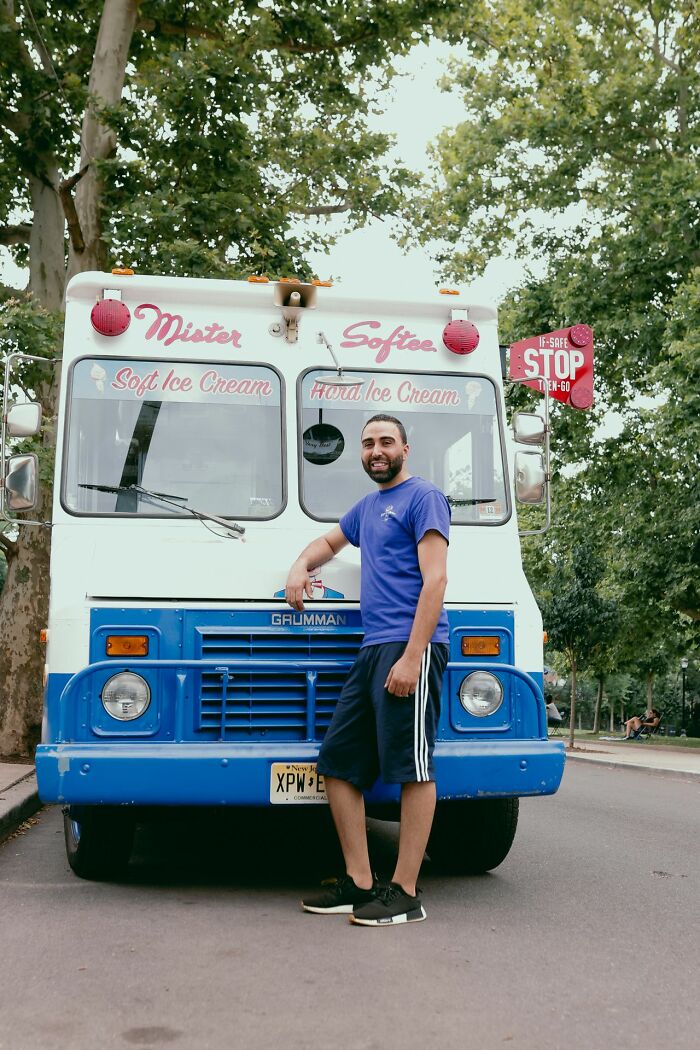 Man standing next to a Mister Softee ice cream truck while trick-or-treating.