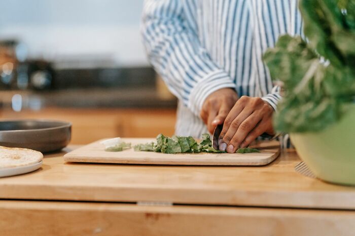 Person chopping greens on cutting board practical life hacks