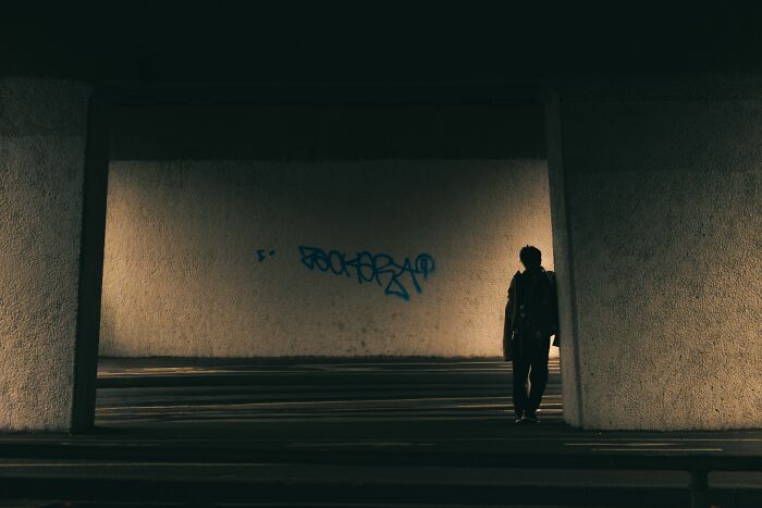Silhouette of a person in a dark tunnel setting the mood for chilling stories