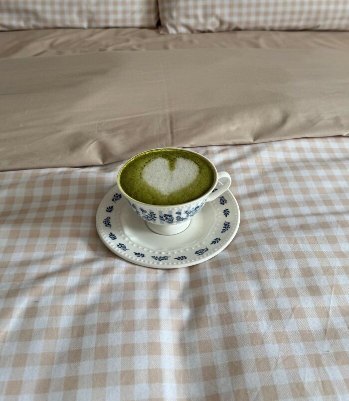 A matcha latte with a heart on a bed representing the quiet mornings after men walk away from marriage
