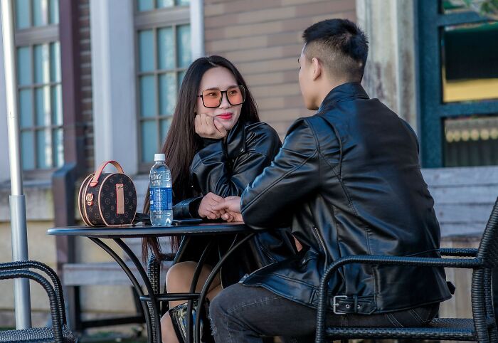 Young woman with sunglasses smiling at a man, showing relationship dynamics and things women wish they understood.