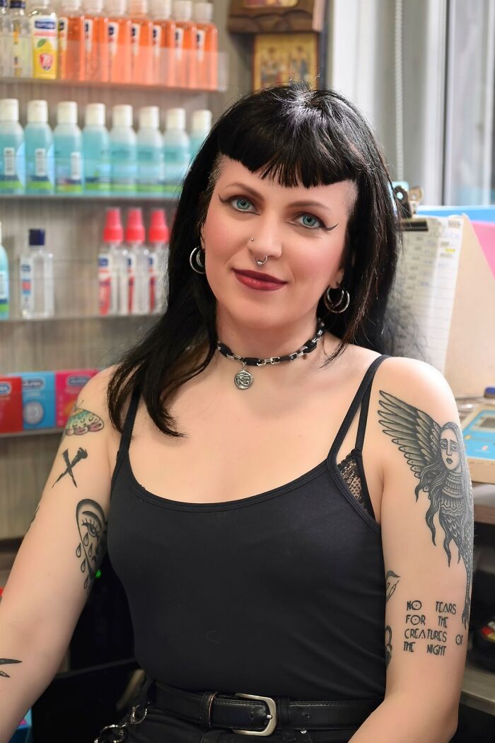 A woman with tattoos looking at the camera, featured in satisfying revenge stories.