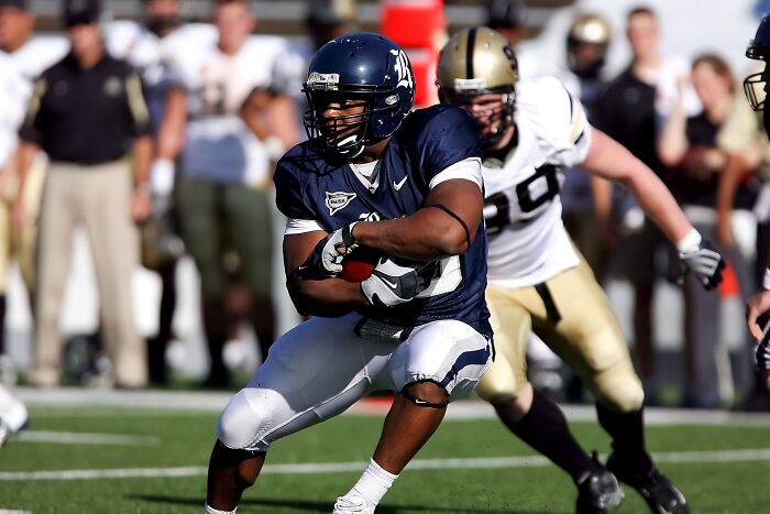 An American football player running with the ball, relating to obvious lies.