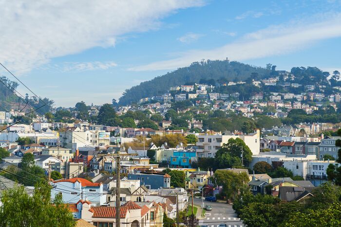 Densely packed houses on a hillside in tiny communities filled with local drama