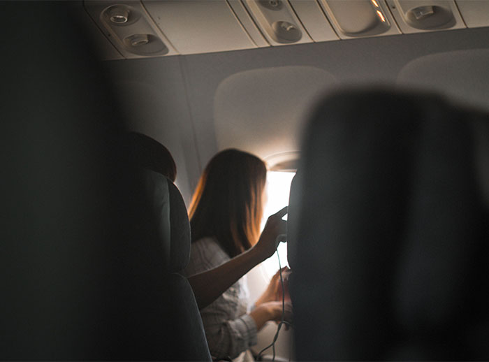 Passenger inside an airplane cabin during a mid-flight travel incident