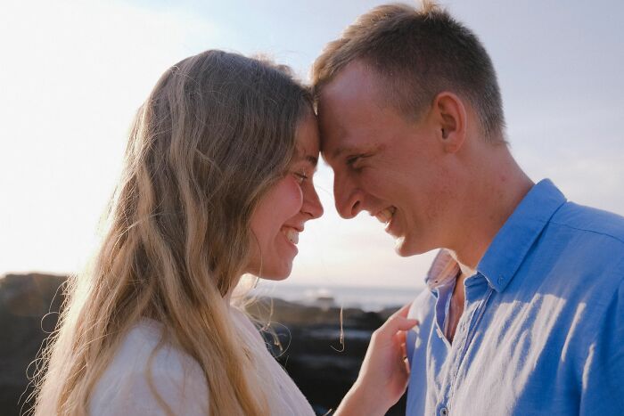 Happy couple smiling close together, reflecting on what made men stay in their marriage.