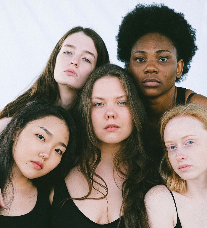 A group of diverse women looking into the camera, sharing important life lessons women wish they knew.