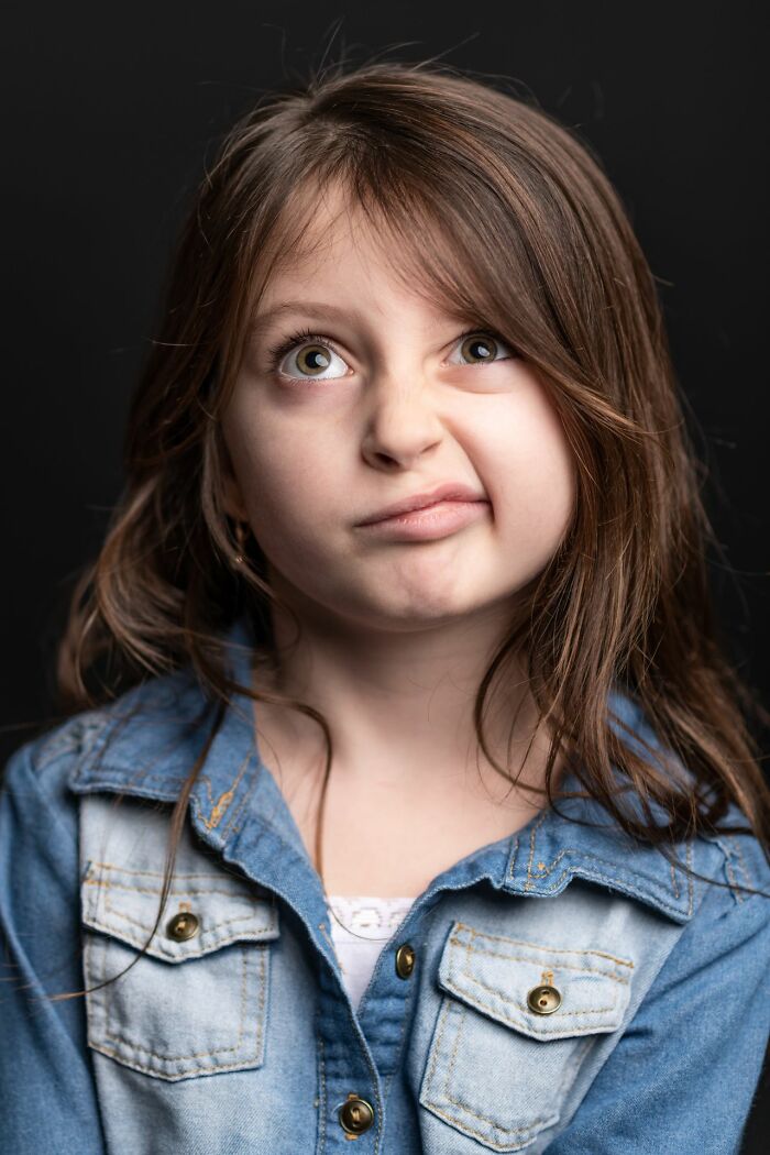 A young girl making a skeptical expression while trick-or-treating instead of getting expected candy.