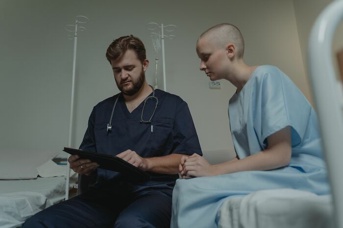 Doctor discussing medical information with female patient in hospital