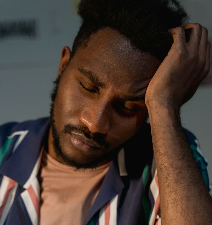 Stressed man leaning on his hand harboring private secrets folks take to the grave.