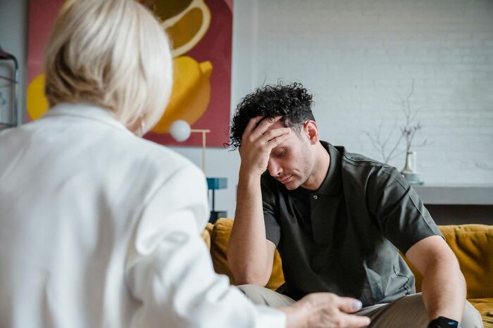 A man holding his head in distress, representing men who walked away from their marriage.