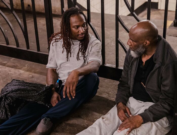 Two men sitting outdoors talking quietly as part of chilling stories of gut feeling