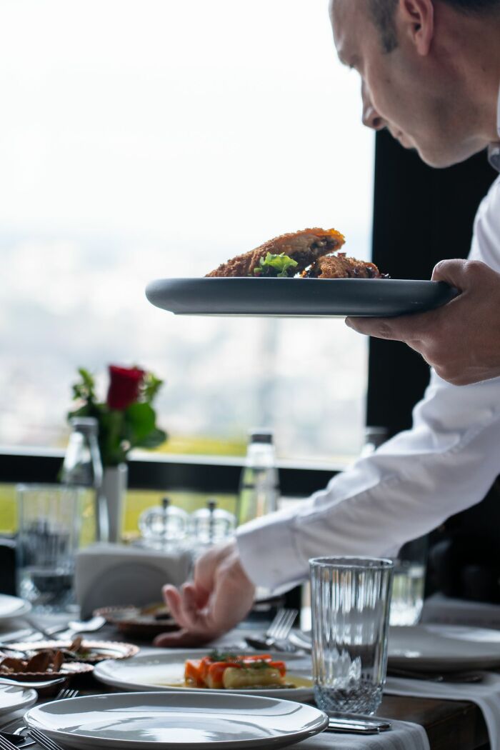 Waiter serving food in restaurant scene related to Karen stories