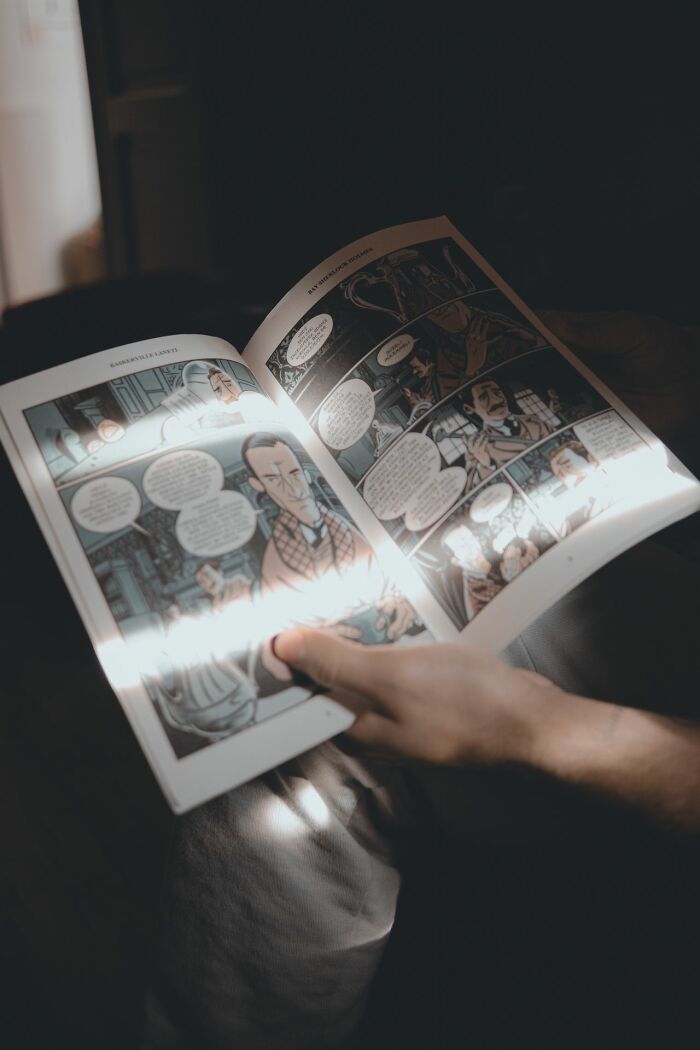 Person reading a comic book instead of getting candy while trick-or-treating.