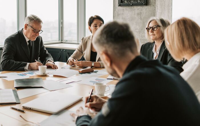 Diverse team in business meeting, discussing microaggressions impact