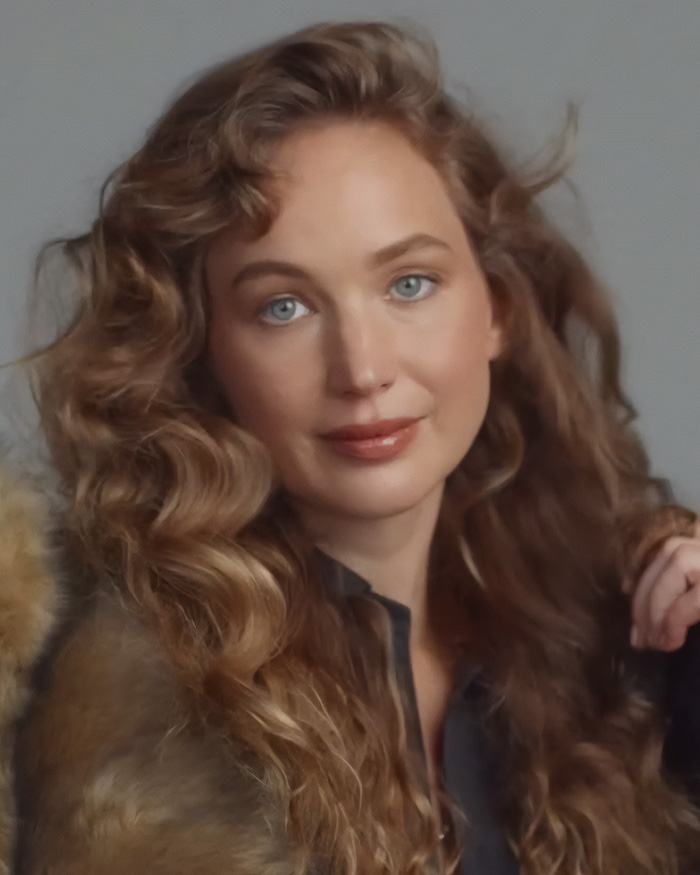 Jennifer Lawrence posing with wavy blonde hair amid plastic surgery rumors.