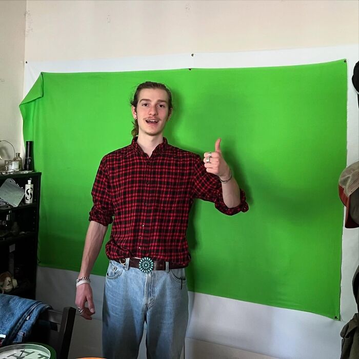 Young man giving a thumbs up, representing positive masculinity and confidence.