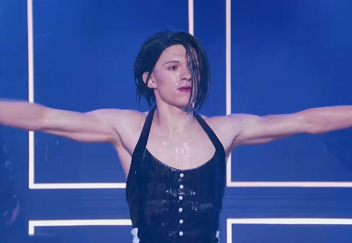 Tom Holland performing energetically, breaking stereotypes as an example of positive masculinity.