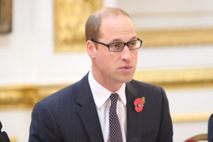 Prince William speaking formally while wearing glasses and suit Prince William speaking formally while wearing glasses and suit