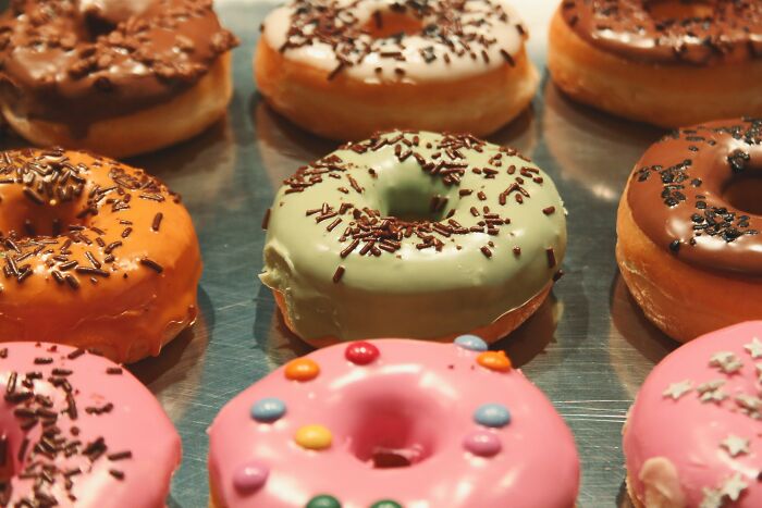 Assorted frosted donuts on a tray representing people who got fired.