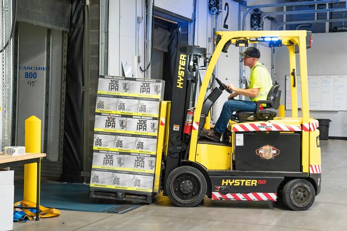 A warehouse worker operating a forklift who might get fired after a workplace mistake